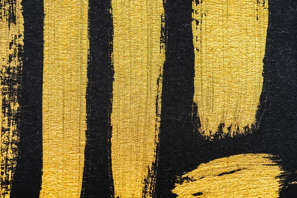 Top view of yellow watercolor brushstrokes on black background — Stock Photo