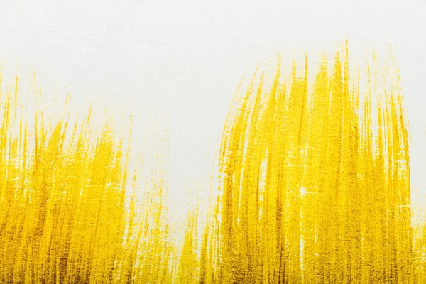 Top view of yellow watercolor brushstrokes with on white paper — Stock Photo