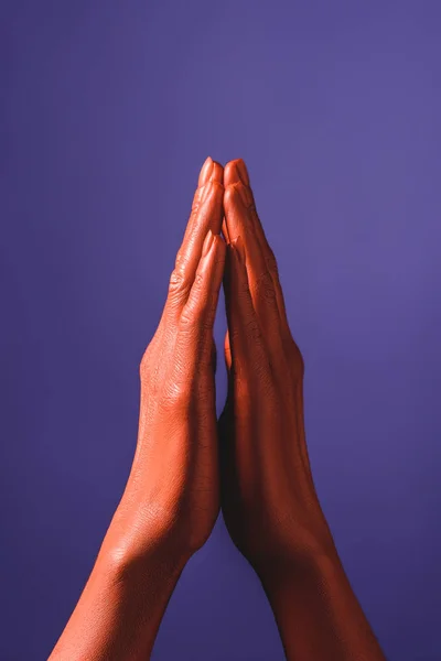 Cropped view of woman with coral colored hands showing pray sign on violet background,  color of 2019 concept — Stock Photo