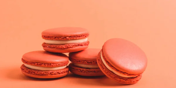 Tasty coral macarons on purple background, color of 2019 concept — Stock Photo