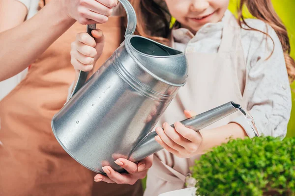 Partial view of man and child with watering can on blurred background, earth day concept — Stock Photo