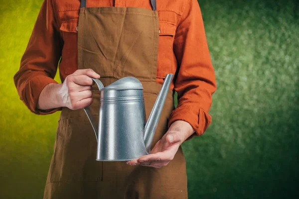 Partial view of man holding watering can on blurred background, earth day concept — Stock Photo