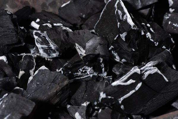 Close up of black burnt textured charcoal with white ash — Stock Photo