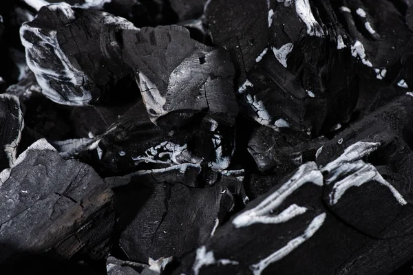 Close up of black burnt textured charcoal with white ash — Stock Photo