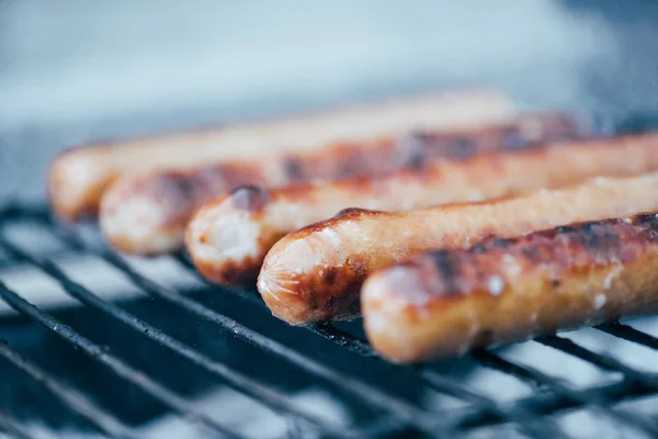 Selective focus of tasty grilled sausages on bbq grill grade — Stock Photo