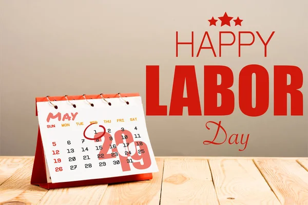 Calendar with 1st May 2019 date isolated on beige with happy labors day red lettering and stars — Stock Photo