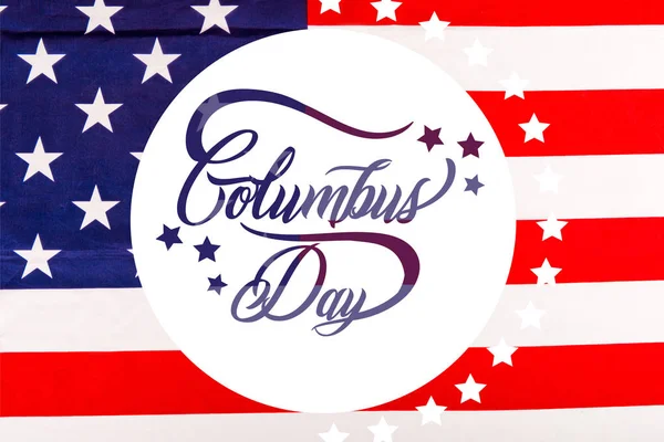 Columbus day lettering in white circle on american flag with stars — Stock Photo