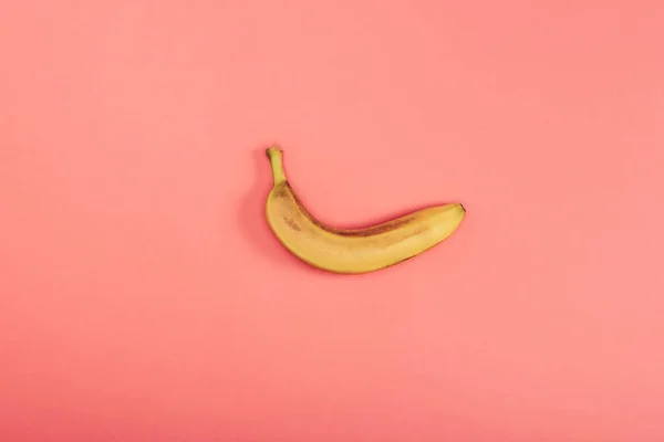 Top view of fresh bright and yellow banana on coral background — Stock Photo