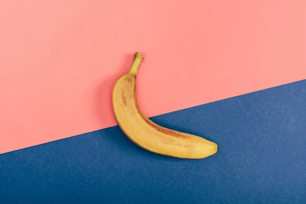 Draufsicht auf frische gelbe Banane auf bunten Korallen und blauem Hintergrund — Stockfoto