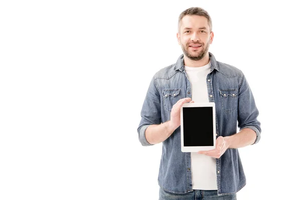 Front view of smiling bearded man in denim shirt holding digital tablet with blank screen isolated on white — Stock Photo