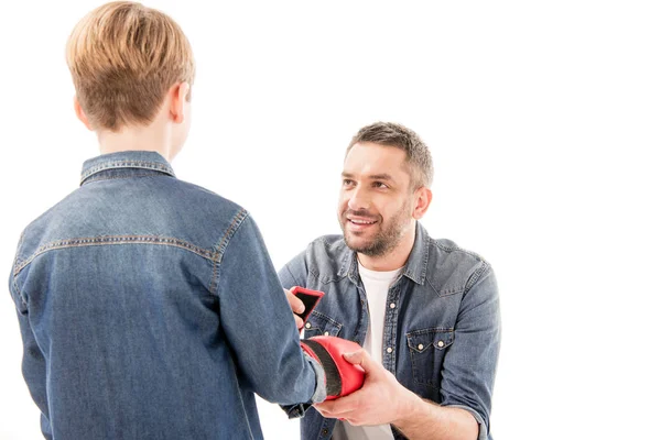 Dad helping son to wear boxing glove isolated on white — Stock Photo