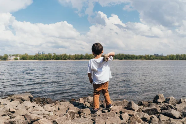 Back View Cute Boy Holding Rock Blue River — Stock Photo, Image