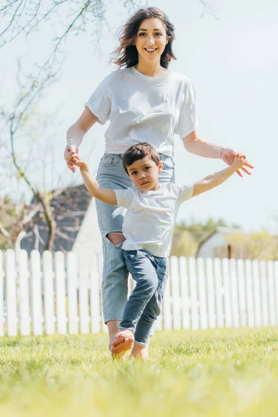 Lycklig Mor Håller Hand Med Söt Son Utanför — Stockfoto