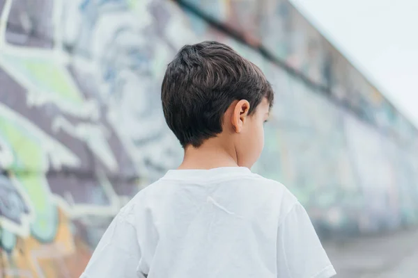 Back view of child in white-t-shirt standing outside — Stock Photo
