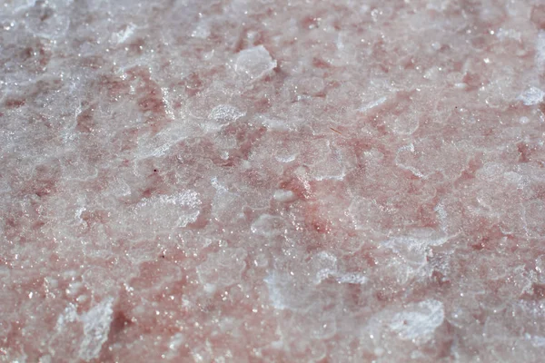 Natural pink salt crystal texture, macro, close up, lamellar structure. Salty lake shore background, Spain, Torrevieja.