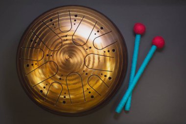 Siyah bir arka plan üzerinde mavi ve kırmızı baget ile Altın asmak davul, üst görünüm