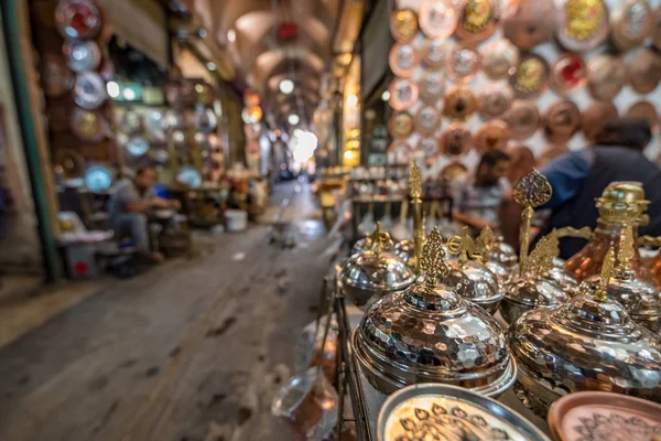 View of shop with lots of copper objects on foreground for sale in  Huseyniye Bazaar,Sanliurfa,Turkey