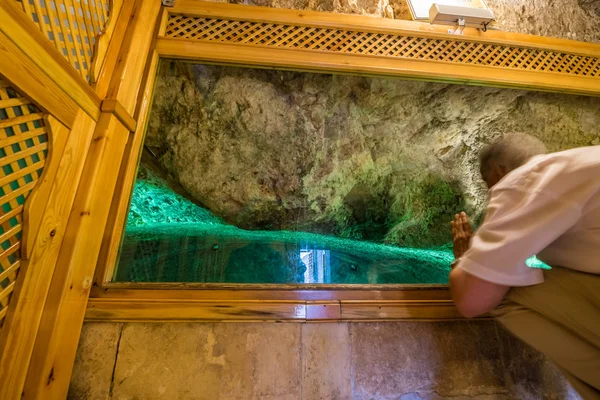 Unidentified man prays in cave where prophet Abraham was born at courtyard of Mevlidi Halil Mosque in Sanliurfa,Turkey.