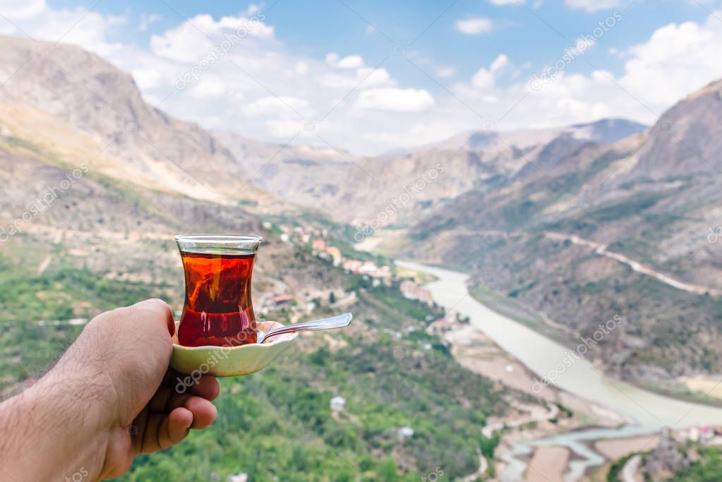 Landscape view of Kemaliye town between valley with Turkish tea on foreground in Kemaliye or Egin,Erzincan,Turke