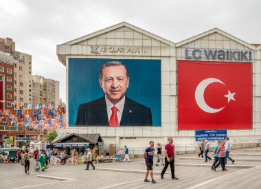 Poster of Turkish Prime Minister Recep Tayyip Erdogan and Turkish flag on a building in Bursa,Turkey.20 May 201 clipart