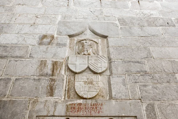 Cross and other signs carved into the wall of ancient Roman marble sculpture in Castle of St. Peter or Bodrum Castle, Turkey.