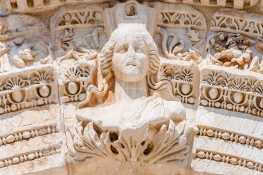 Marble reliefs in Ephesus historical ancient city, in Selcuk,Izmir,Turkey.Figure of Medusa with ornaments of Acanthus leaves,Detail of the Temple of Hadrian. clipart