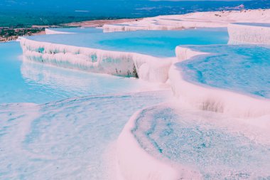 Turquoise color view of Pamukkale (Cotton Castle) is popular with Travertine pools and terraces  where people love to visit in Pamukkale, Turkey. clipart