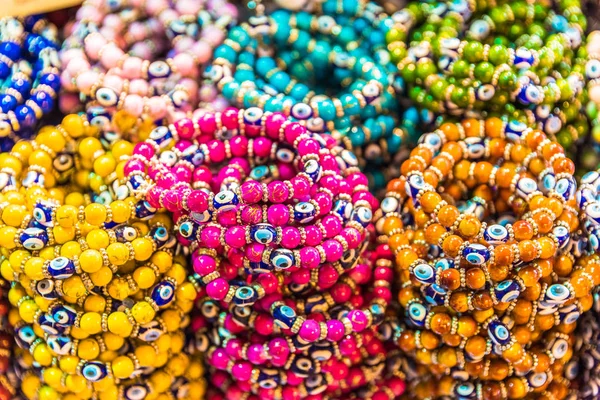 Collection of Traditional Turkish colorful bead bracelets made from glass on display for sale in a Turkish bazaar
