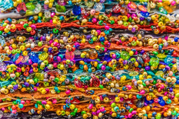 Traditional colorful silk ,cashmere head scarves or shawls and fabrics composed of a stack background at the bazaar stall in Istanbul, Turkey