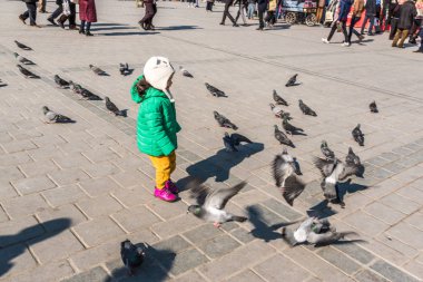 Istanbul/Türkiye-Aralık 24,2016: Yeni Camii (Yeni Camii) güvercinlerin tanımlanamayan Çocuk besleme. Yeni Camii İstanbul ' da bulunan 1665, tamamlanmış bir Osmanlı imparatorluk camiidir.