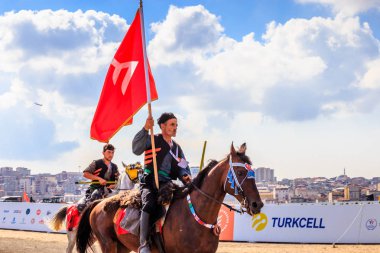 Retro kostüm eski Türk askeri ve Osmanlı asker kimliği belirsiz adam tanımsız bir bayrak ile ata binme. Istanbul, Türkiye - 28 Ağustos 2016