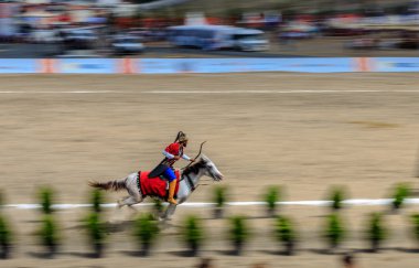 Eski Türk askeri ve Osmanlı askerleri kostümleri tanımlanamayan Ortaçağ okçu ok ve eğri ile bir Target atlı hedeflemektedir. Istanbul, Türkiye - 28 Ağustos 2016