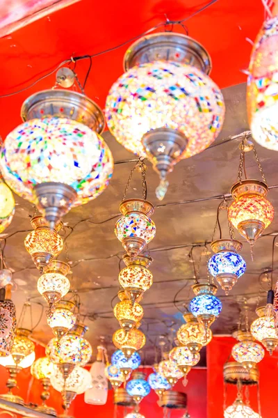 Traditional colorful handmade Turkish lamps and lanterns hanging in souvenir shop for sale