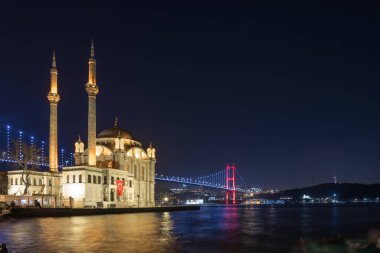 Exterior view of Ortakoy Mosque with15 July Martyrs Bridge or unofficially Bosphorus Bridge also called First Bridge over bosphorus in Istanbul,Turkey.03 January 2018 clipart