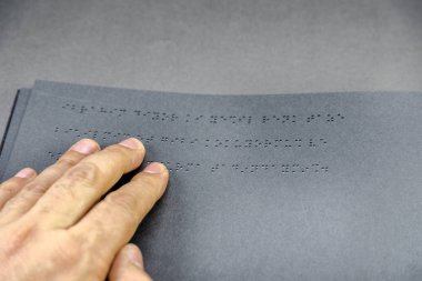 Üstten görünüm kör insanlar için braille alfabesi ile yazılmış bir kitap okuma kör birine el. Alanı düzenlemek için kopyalayın. Istanbul,Turkey.10 Şubat 2017