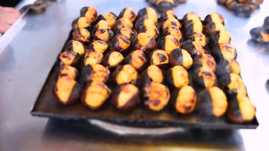 Kahverengi pişmiş kavrulmuş kestane yemek ve satmak bir stand yakın çekim.