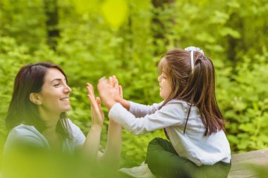 Genç anne ve küçük kızı birlikte eğleniyorlar. 