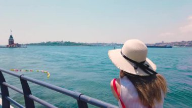 Slow Motion: güzel kız, Üsküdar kasabasında Bosphorus and Maidens Kulesi 'nin fotoğraflarını çeker, Istanbul, Türkiye