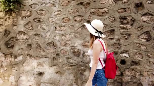 Beautiful Young Girl Touches Wall While Walking Street Travel Concept — стоковое видео