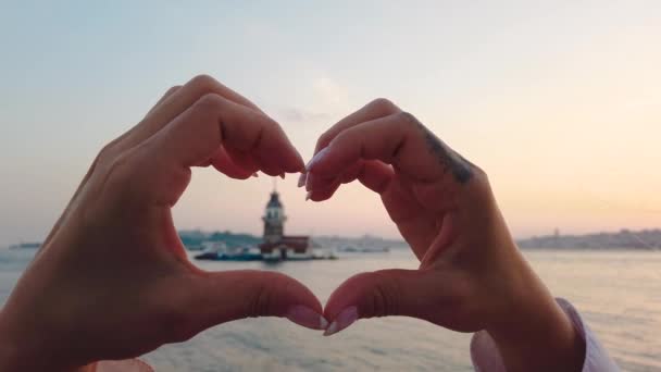 Slow Motion Beautiful Girl Makes Heart Shape View Maiden Tower — Stock Video