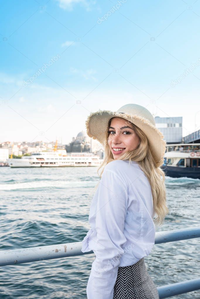 Beautiful girl poses with bosphorus sea view