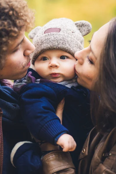 Young family hugging in autumn in park. — Stock Photo, Image