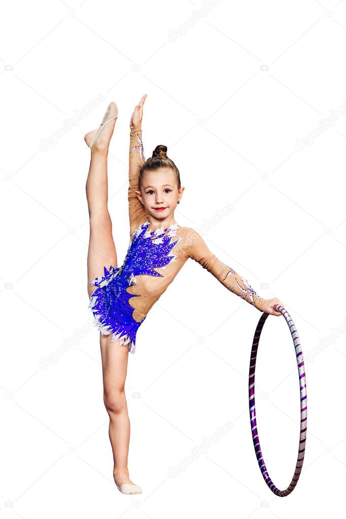 Little girl is engaged in rhythmic gymnastics with hoop isolated on white.