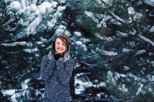 Stylish cheerful girl in a sweater in the winter forest. — Stock Photo, Image