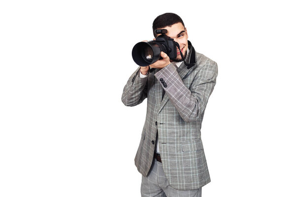 photographer at work. stylish young bearded guy takes pictures on digital camera