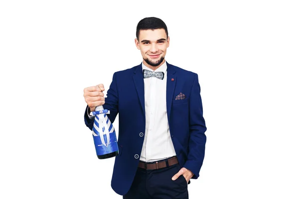 Elegante jongeman in een blauwe pak met een gedecoreerde fles champagne of wijn — Stockfoto