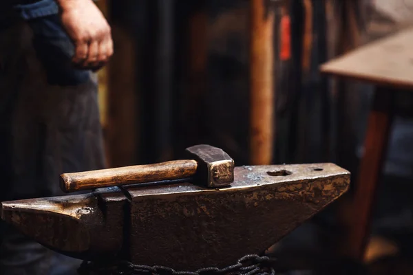 closeup of a blacksmith\'s hammer on the anvil.