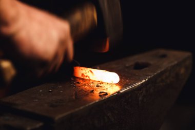 Demirci sıcak metal bir sanatsal dövme örs üzerinde yapar..