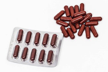 blister tıbbi kahverengi kapsüller ve beyaz arka plan üzerinde olmadan.