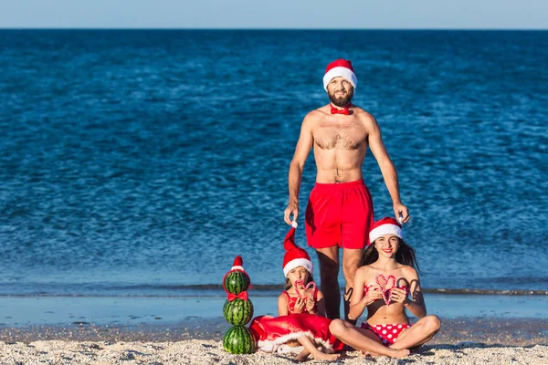 Young friendly fun family celebrates summer Christmas